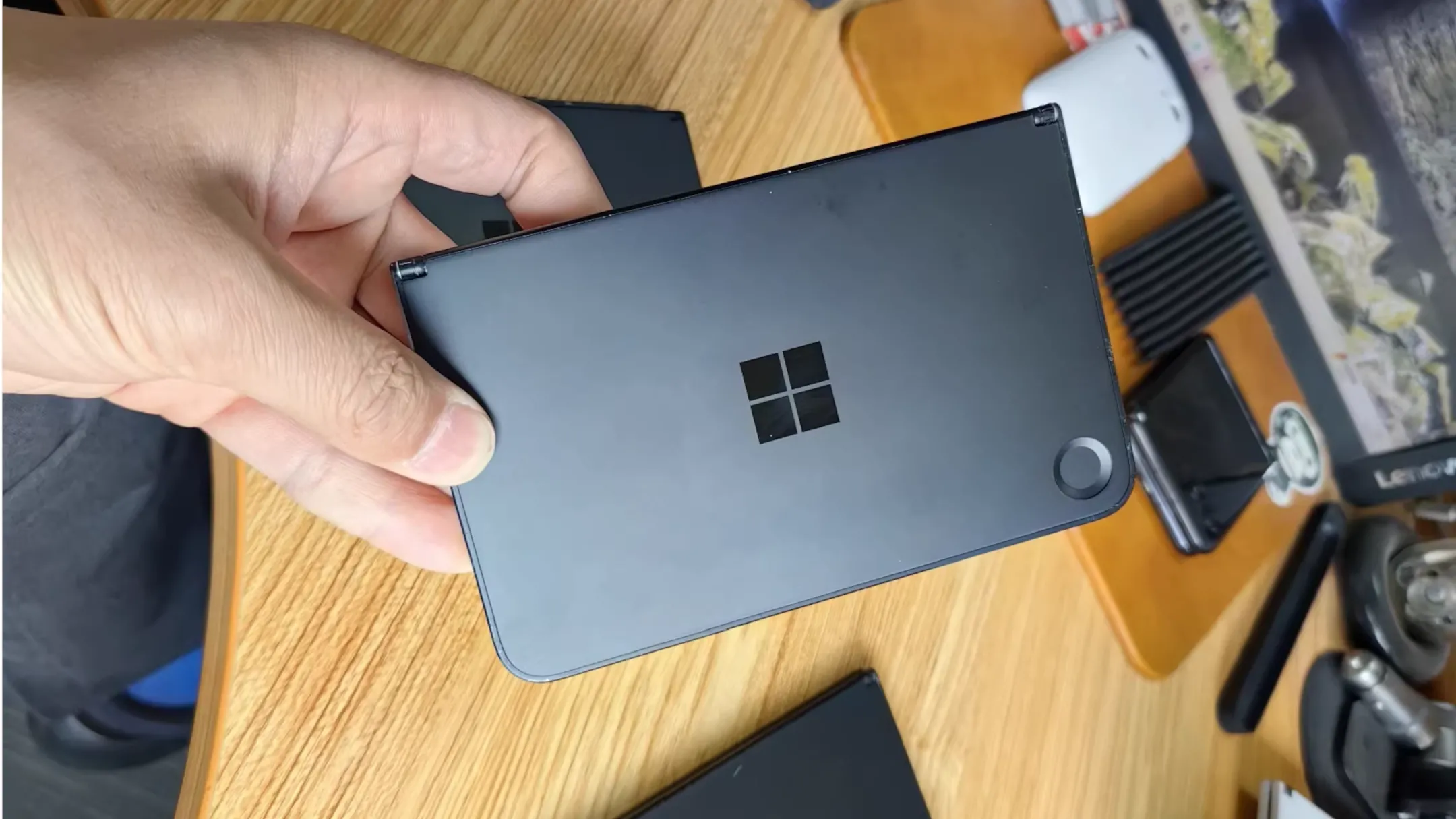 Hình ảnh nguyên mẫu điện thoại gập Microsoft Surface Andromeda với hai màn hình và camera sau, cho thấy thiết kế tổng thể cùng các vết hao mòn và nứt.
