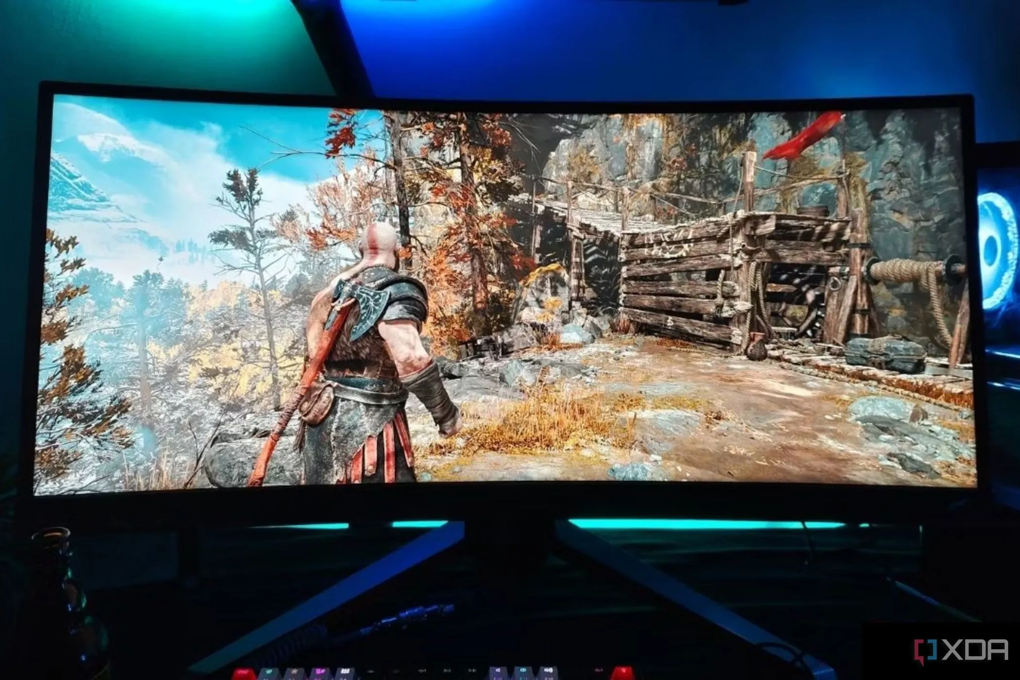 Màn hình chơi game siêu rộng BenQ Mobiuz EX3415R hiển thị trò chơi God of War, nổi bật với hệ thống loa tích hợp.