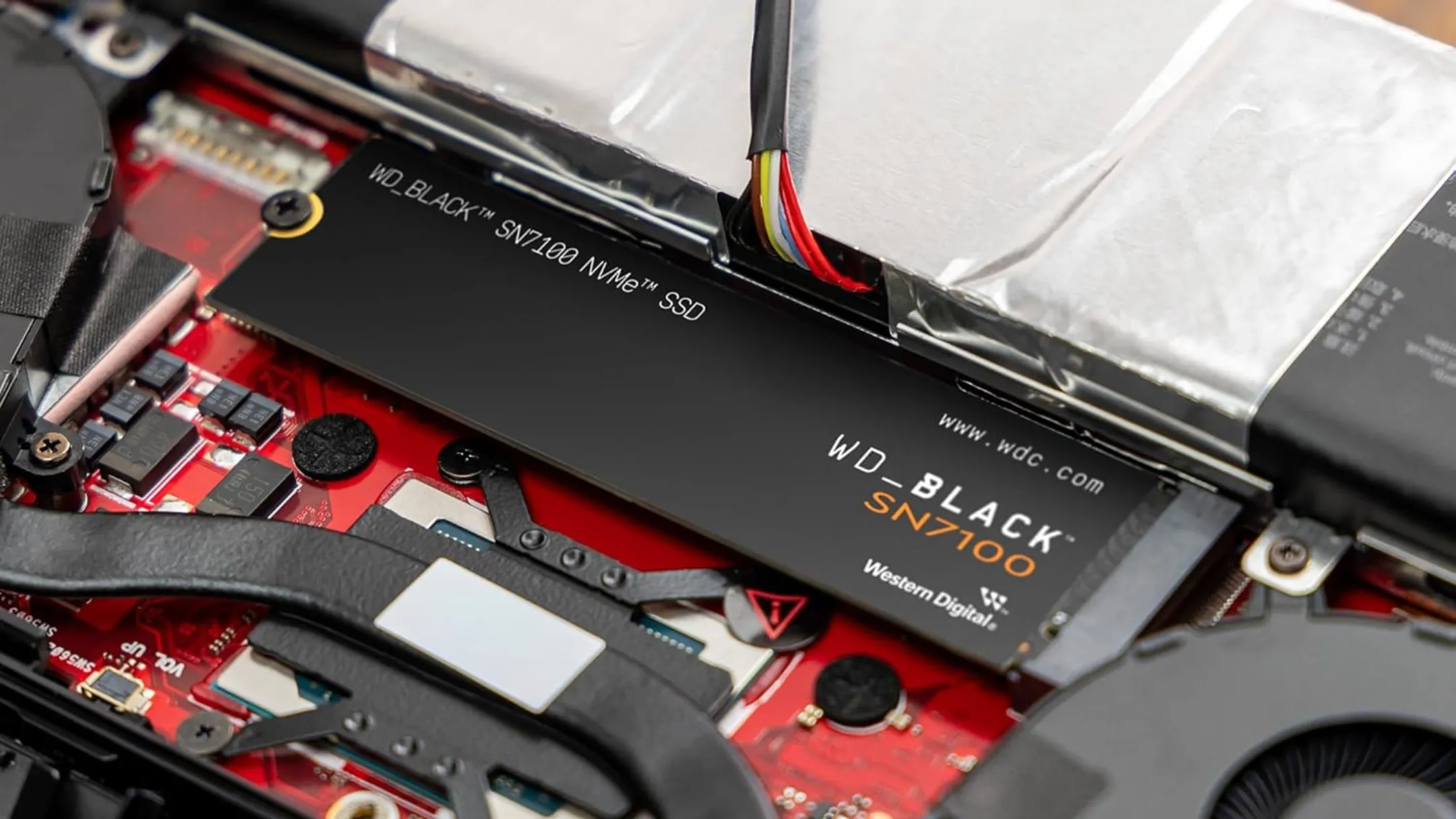 Ổ cứng SSD WD_BLACK SN7100 4TB NVMe được lắp đặt trong thiết bị chơi game hoặc máy tính.