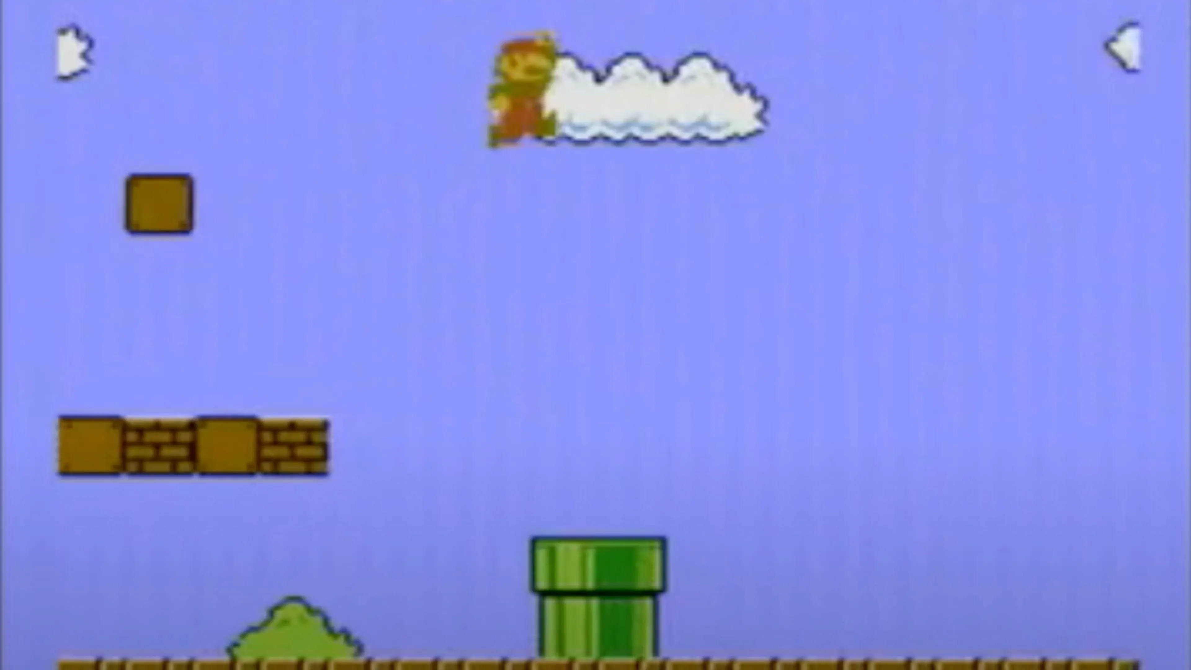 Screenshot gameplay Super Mario Bros. cho thấy Mario đang nhảy qua các khối gạch trong một cấp độ cổ điển, minh họa đồ họa 8-bit đặc trưng của game NES.